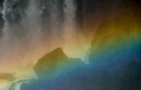 Intense rainbow at the base of a falls.© 2013 Bob Harvey